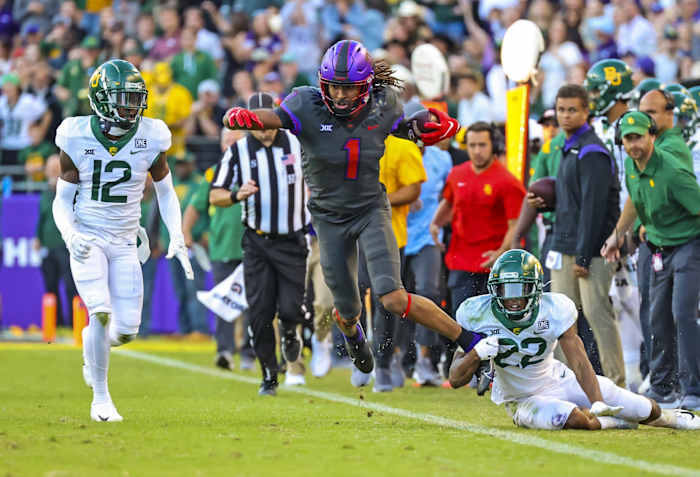 TCU Horned Frogs wide receiver Quentin Johnston (1) is tackled by Baylor Bears safety JT Woods (22) during the second half at Amon G. Carter Stadium
